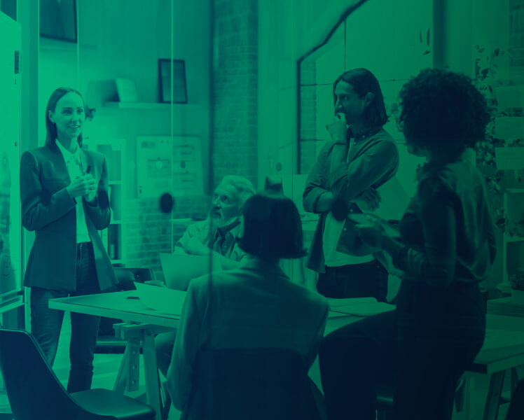 A woman giving a presentation to her colleagues