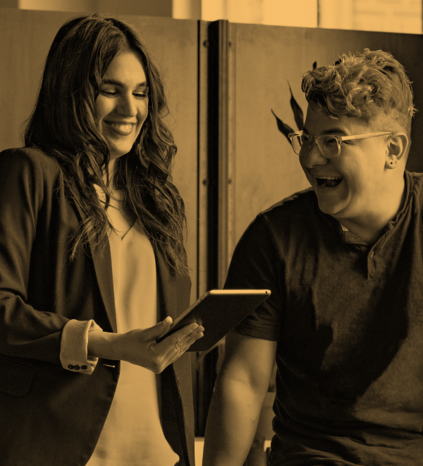 Two coworkers reviewing a report and smiling